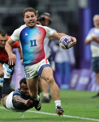 France’s Antoine Dupont races away from the Fiji defence