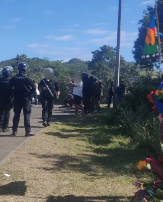French riot police near the spot - marked with a tribal offering - where 19-year-old Jybril Salo was shot in the back last May.
