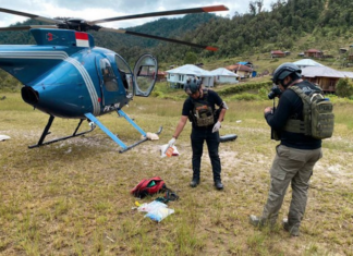 Operation Peace Cartenz investigators at the scene where New Zealand helicopter pilot Glen Malcolm Conning was reportedly shot dead