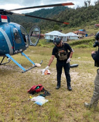 Operation Peace Cartenz investigators at the scene where New Zealand helicopter pilot Glen Malcolm Conning was reportedly shot dead