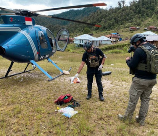 Operation Peace Cartenz investigators at the scene where New Zealand helicopter pilot Glen Malcolm Conning was reportedly shot dead