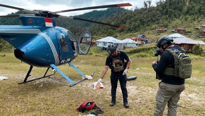 Operation Peace Cartenz investigators at the scene where New Zealand helicopter pilot Glen Malcolm Conning was reportedly shot dead