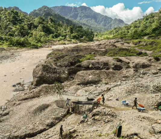 Artisanal miners search for gold in the waters downstream from the Panguna mine