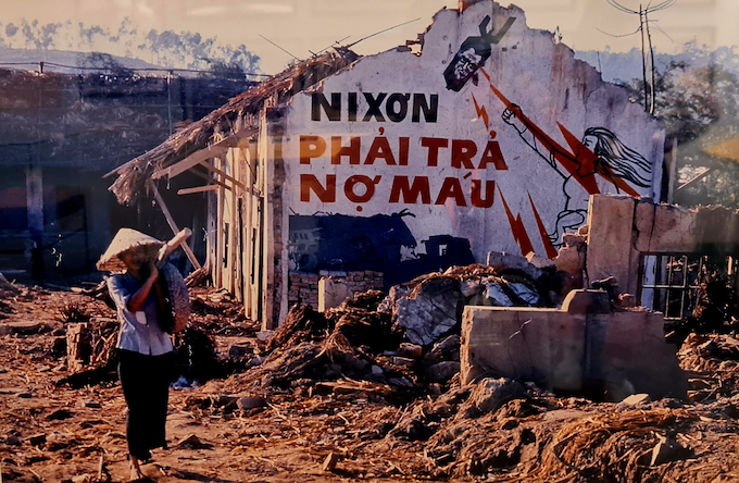 "Nixon out of Vietnam" daubed on a bombed house 