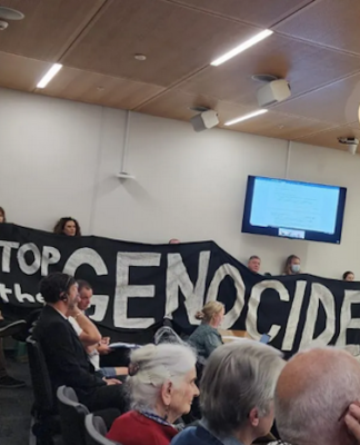 NZ’s Labour calls on other cities to follow Israel boycott lead Christchurch citizens hold up a "Stop the genocide" banner before yesterday's council vote