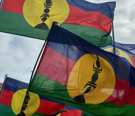 Kanak flags lifted high at a pro-independence rally in Nouméa
