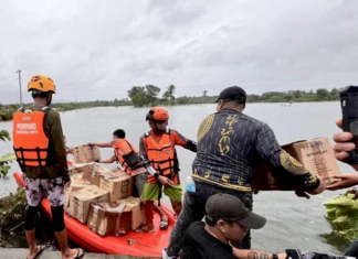 Filipino rescuers at work in Mangcayo barangay near Vinzons, Bicol