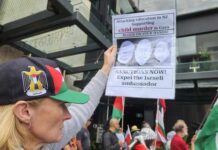 A New Zealand protester at a pro-Palestinian rally in Auckland on Saturday calling for immediate sanctions and the expulsion of the Israel ambassador