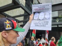 A New Zealand protester at a pro-Palestinian rally in Auckland on Saturday calling for immediate sanctions and the expulsion of the Israel ambassador