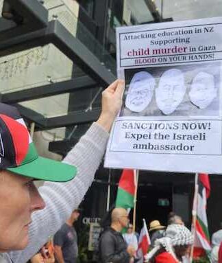 A New Zealand protester at a pro-Palestinian rally in Auckland on Saturday calling for immediate sanctions and the expulsion of the Israel ambassador