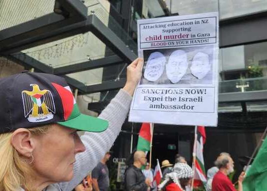 A New Zealand protester at a pro-Palestinian rally in Auckland on Saturday calling for immediate sanctions and the expulsion of the Israel ambassador