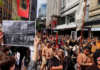 John Miller's photograph of the 1975 Land March held up in the same location at the 2024 Hīkoi mō te Tiriti in Pōneke Wellington.