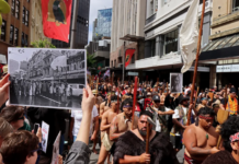 John Miller's photograph of the 1975 Land March held up in the same location at the 2024 Hīkoi mō te Tiriti in Pōneke Wellington.