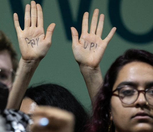 A protester at COP29 calls on wealthy nations to "pay up"