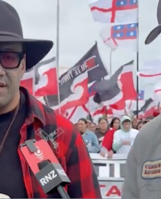 Te Maori Pati leader Rawiri Waititi talks to an RNZ reporter at Hīkoi mō te Tiriti