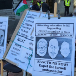 A "Netanyahu wanted for child killing" placard at a Palestine solidarity rally in Auckland this month