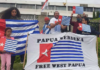 A "raising the Morning Star" flag protest outside the Indonesian Embassy in Canberra in 2021