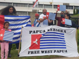 A "raising the Morning Star" flag protest outside the Indonesian Embassy in Canberra in 2021