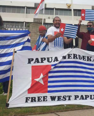 A "raising the Morning Star" flag protest outside the Indonesian Embassy in Canberra in 2021