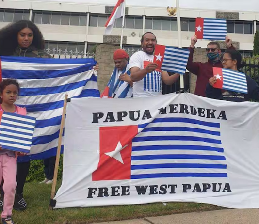 A "raising the Morning Star" flag protest outside the Indonesian Embassy in Canberra in 2021