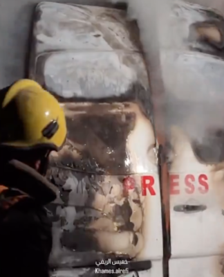 The burnt out vehicle with the clearly visible "Press" label in which an Israeli strike killed the five journalists in Gaza