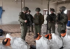 This screenshot from a video broadcast on Israeli channel Now 14 shows an officer and four soldiers of Israel’s Givati Brigade standing next to Palestinian detainees