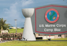 US Marines run past the Camp Blaz