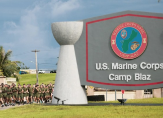 US Marines run past the Camp Blaz