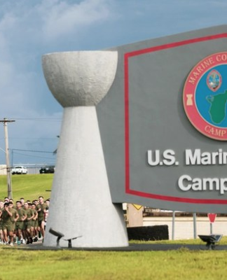 US Marines run past the Camp Blaz