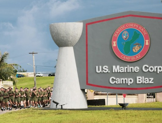 US Marines run past the Camp Blaz