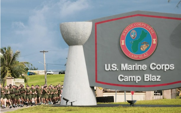 US Marines run past the Camp Blaz
