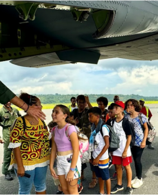 A group of schoolchildren boarding a military aircraft