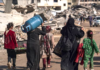 Displaced Palestinians walk through the destruction in Rafah in southern Gaza