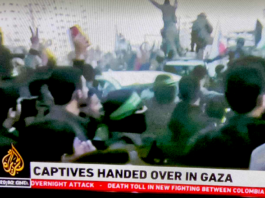 Armed Hamas fighters escort the Israeli captives