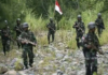 Indonesia defends high number of military deployed in Papua Indonesian military forces on patrol in the Oksop regency