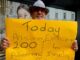 A protester for Palestine holds up a poster in Te Komititanga Square