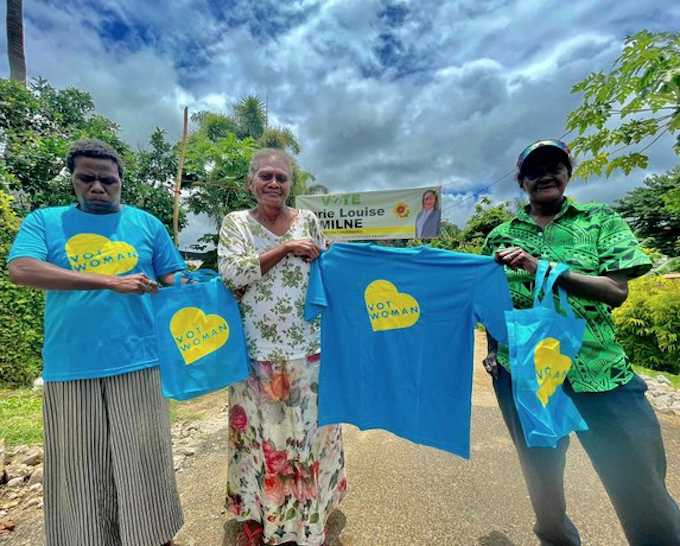 Campaigners for women parliamentarians hold “Vot Woman” t-shirts