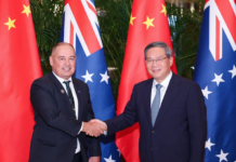 Chinese Premier Li Qiang meets with Cook Islands Prime Minister Mark Brown (left) in Harbin