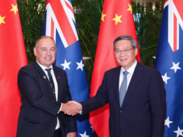 Chinese Premier Li Qiang meets with Cook Islands Prime Minister Mark Brown (left) in Harbin