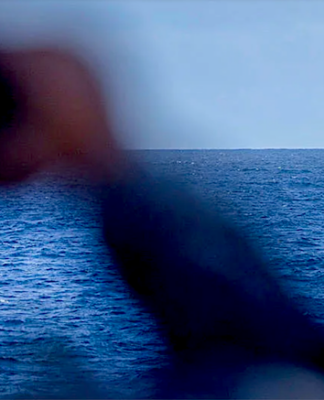 A crew member on board the RAN frigate HMAS Stuart monitors the Chinese Navy's missile destroyer Zunyi and the supply ship Weishanhu