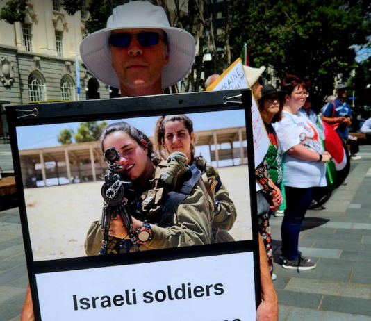 An Israeli soldiers "not welcome" placard at the Palestine solidarity rally and march in the heart of New Zealand's largest city Auckland today