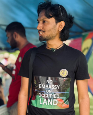 Fiji solidarity group condemns Rabuka plans for embassy in Jerusalem A Fijians for Palestine supporter shows off his "No embassy on occupied land" tee-shirt