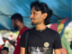 A Fijians for Palestine supporter shows off his "No embassy on occupied land" tee-shirt