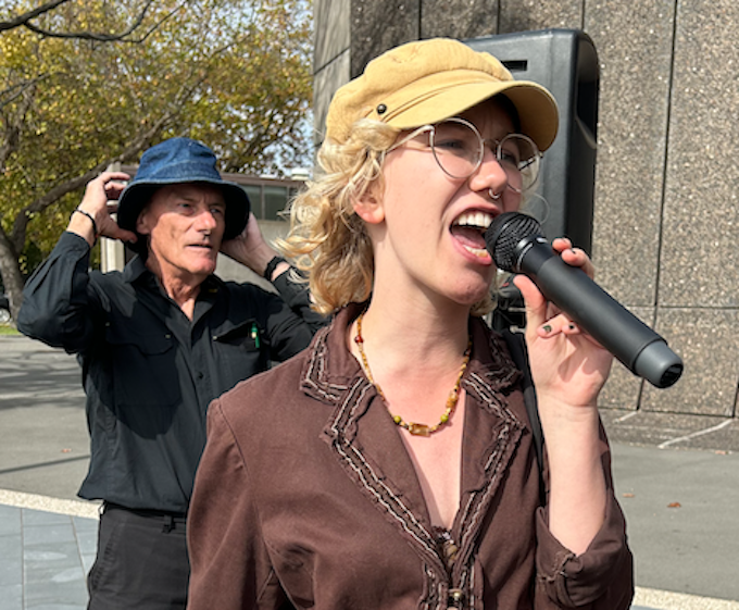 PSNA co-chair John Minto (in hat behind fellow protester)