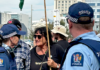 Face to face . . . a pro-Palestinian and human rights protester up close with police at the Christchurch Town Hall