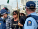 Face to face . . . a pro-Palestinian and human rights protester up close with police at the Christchurch Town Hall