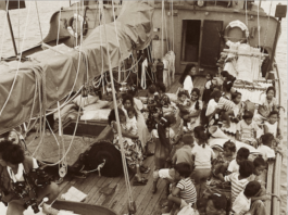 This photograph shows Rongelap Islanders on board the Greenpeace flagship Rainbow Warrior travelling to their new home on Mejatto Island in 1985