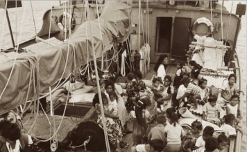 This photograph shows Rongelap Islanders on board the Greenpeace flagship Rainbow Warrior travelling to their new home on Mejatto Island in 1985