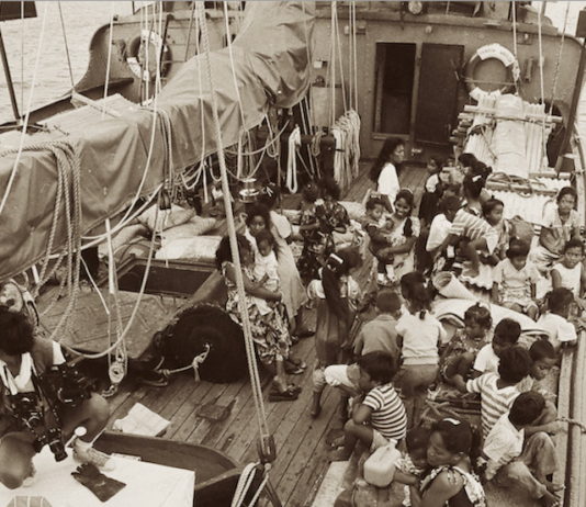 This photograph shows Rongelap Islanders on board the Greenpeace flagship Rainbow Warrior travelling to their new home on Mejatto Island in 1985