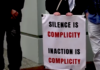 "Silence is complicity" . . . a placard on a sign at the protest outside the Israeli Embassy in Wellington today